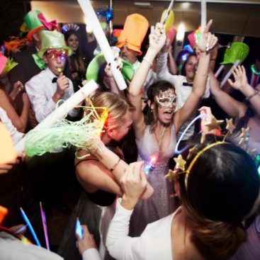 young people wearing hats and masks partying