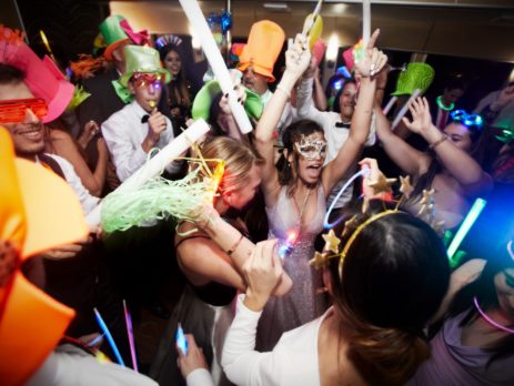 young people wearing hats and masks partying